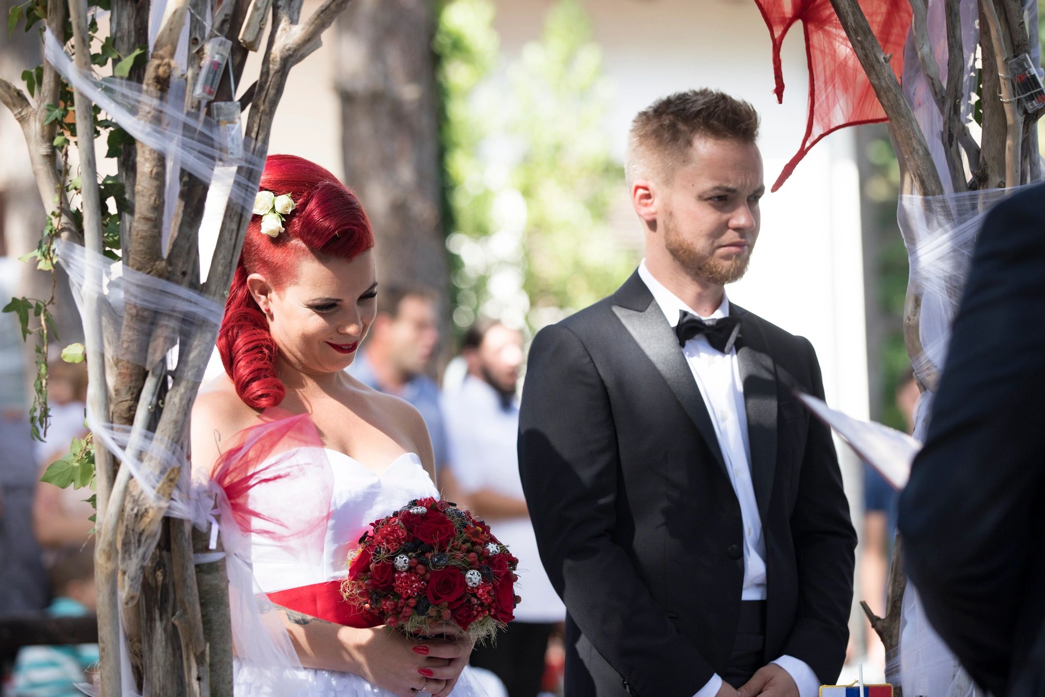 Couple listening to an officiant during a wedding ceremony