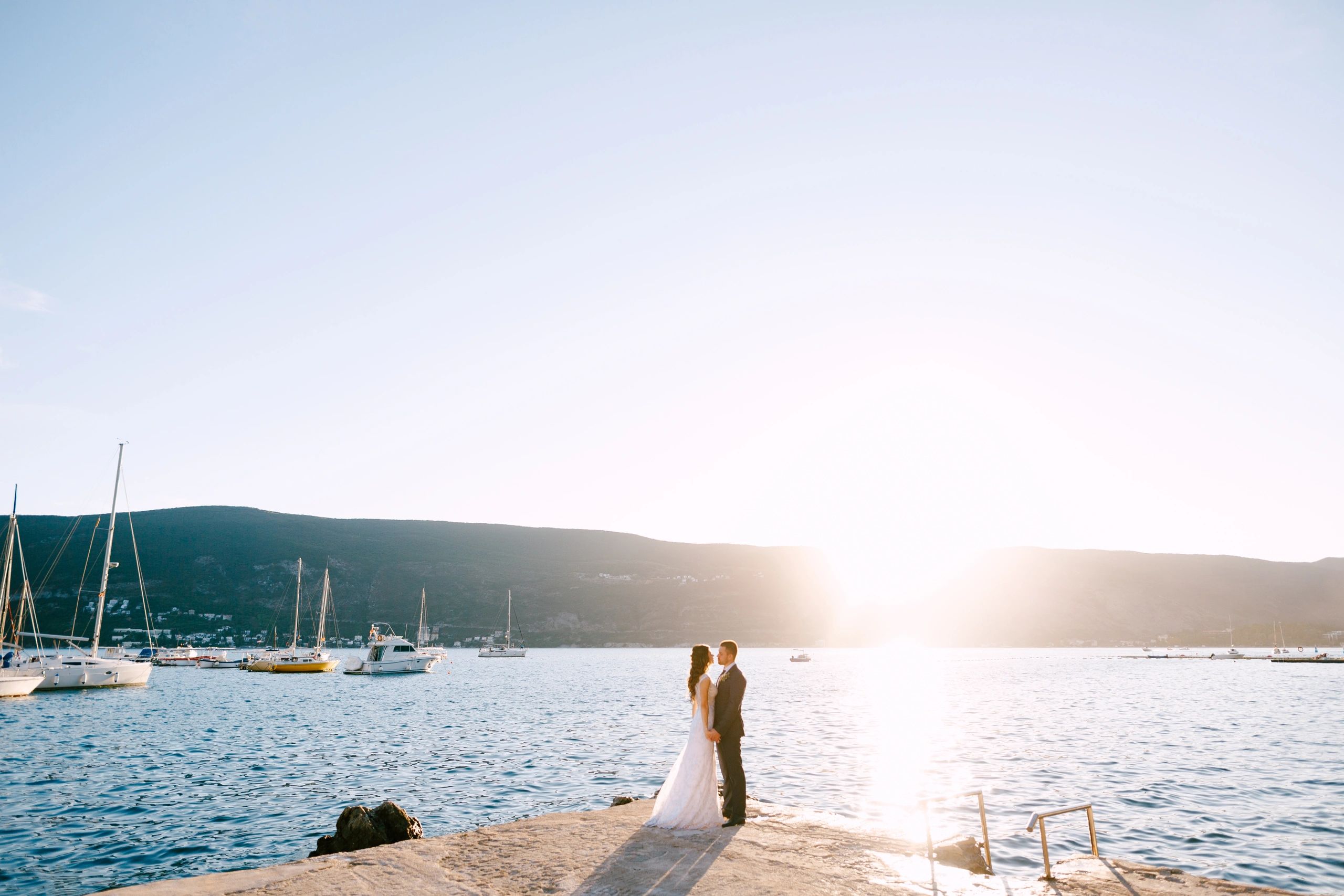 Bride and groom holding hands on a sunny day