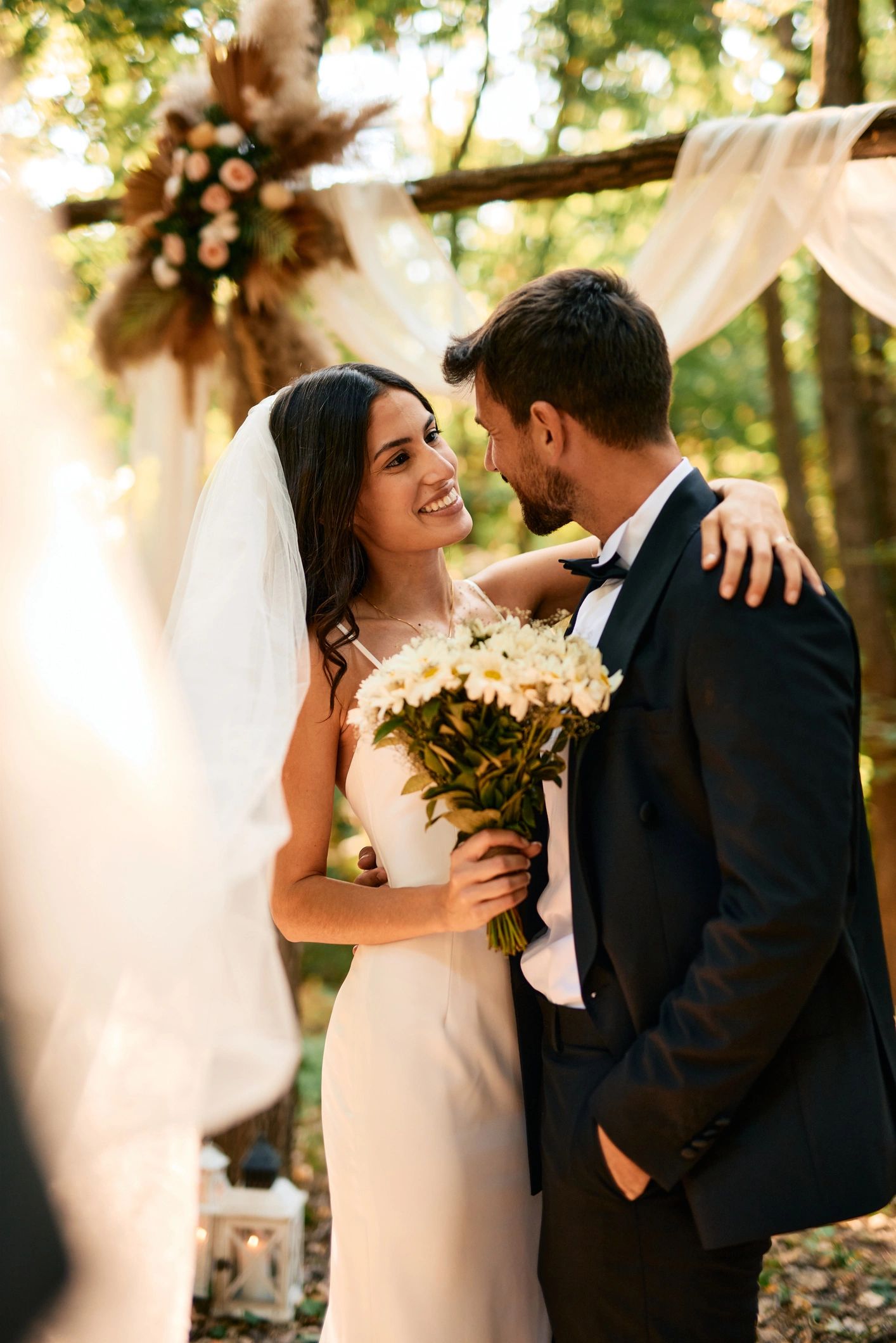 Couple embracing during an outdoor wedding ceremony