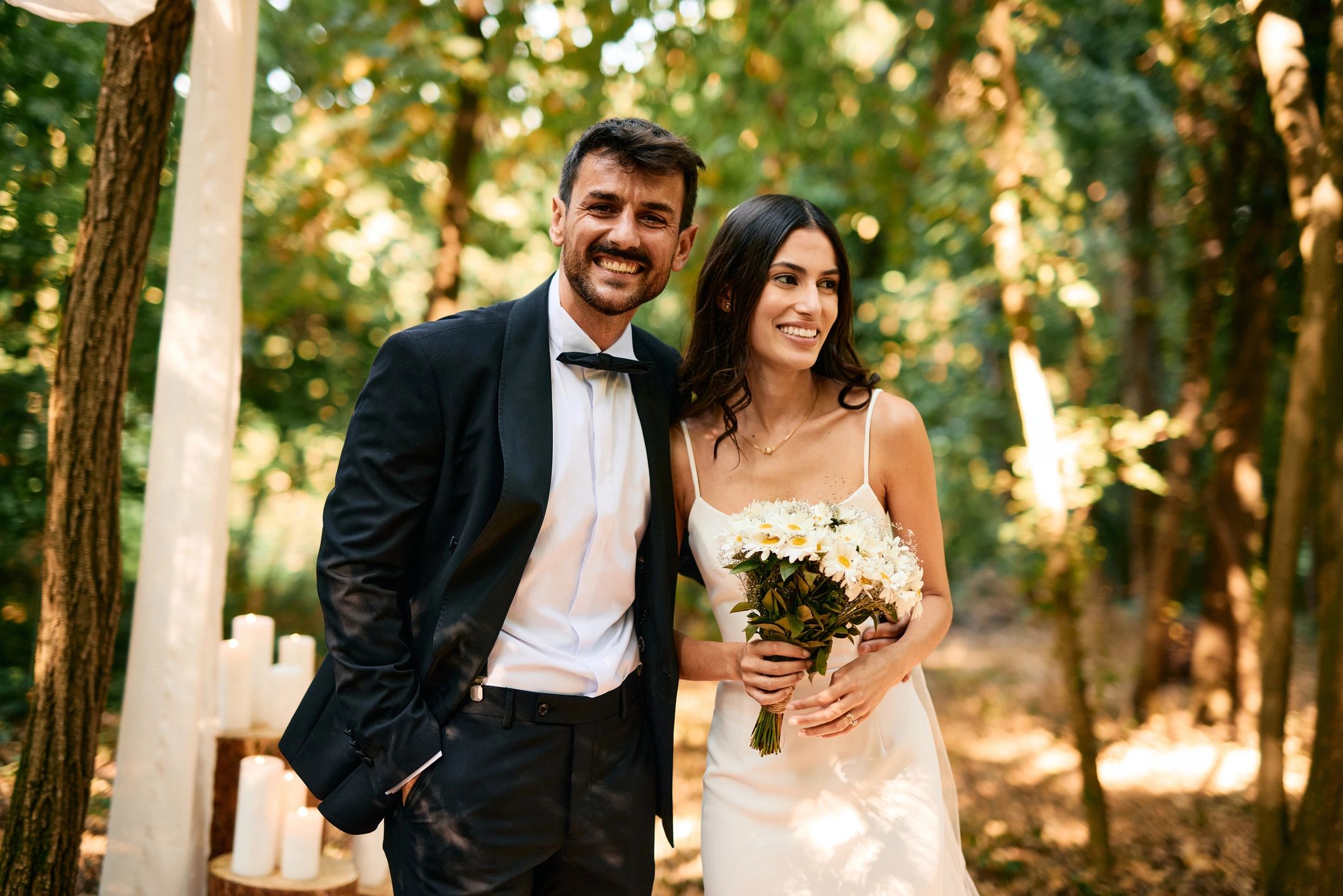 Happy couple smiling during an outdoor wedding ceremony